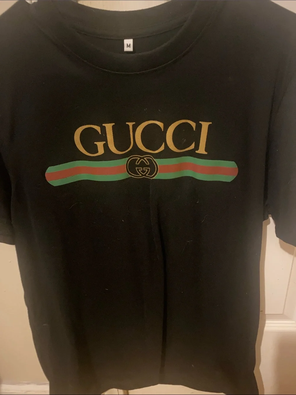 Gucci Black Tee with Gold Logo and Green-Red Stripe